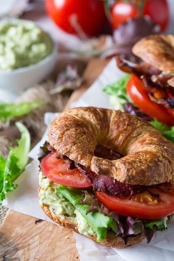 This avocado egg salad BLT is the perfect spring sandwich. Hard boiled eggs and creamy avocado pilled high on a croissant with crispy bacon, lettuce and tomato.