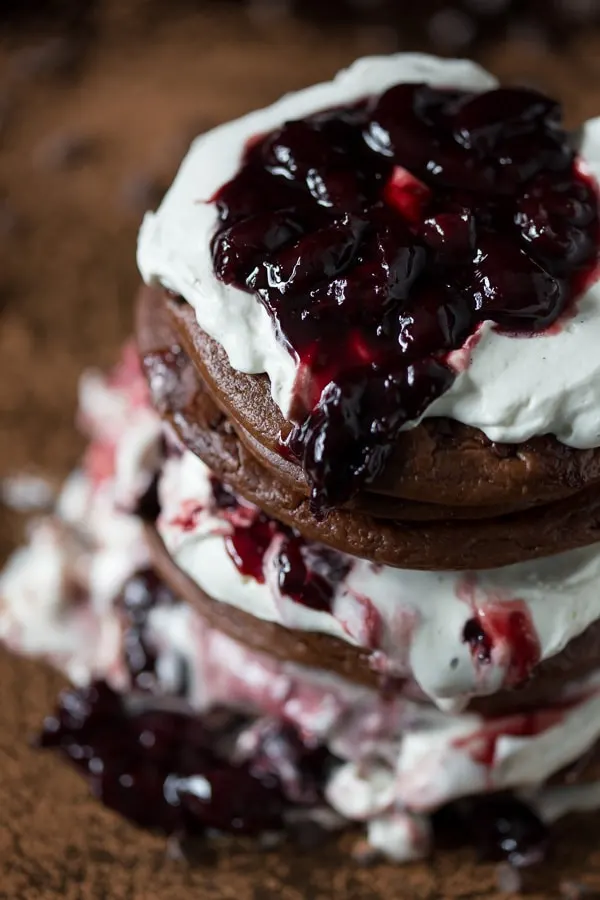 These gluten free black forest pancakes are layered with sweet breakfast flavor. Super chocolaty gluten free pancakes paired with cherries and vanilla bean whipped cream. 