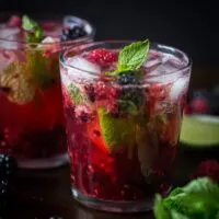 This sweet mixed berry mojito cocktail combines delicious fresh raspberries, blackberries, mint and rum. It's super delicious, perfect for spring and takes only 5 minutes to make!