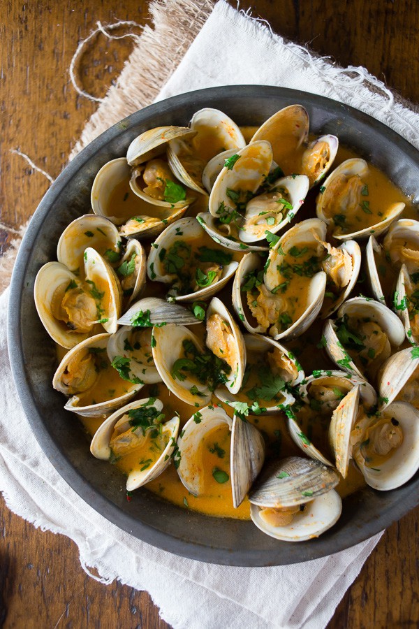 These spicy coconut milk clams are packed full of Thai flavor and cook in less than 20 minutes. It's full of spicy red chiles and sweet coconut milk to create the perfect sweet and spicy seafood combination.