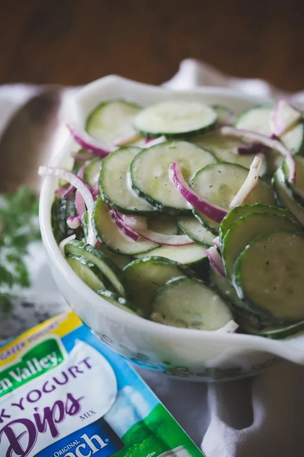 greek yogurt ranch cucumber salad in a bowl with a small packet of ranch seasoning on the side