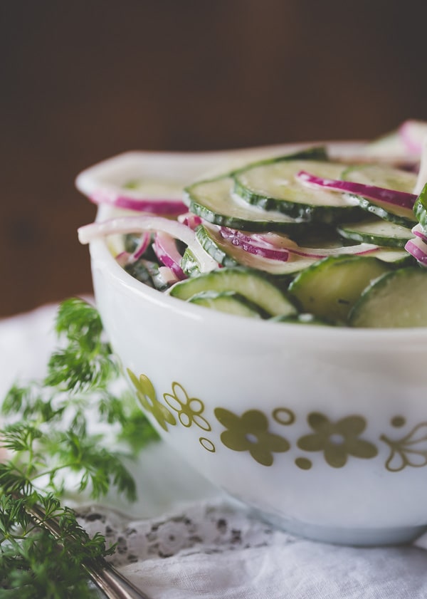sliced cucumbers and red onions in a bowl for greek yogurt ranch cucumber salad