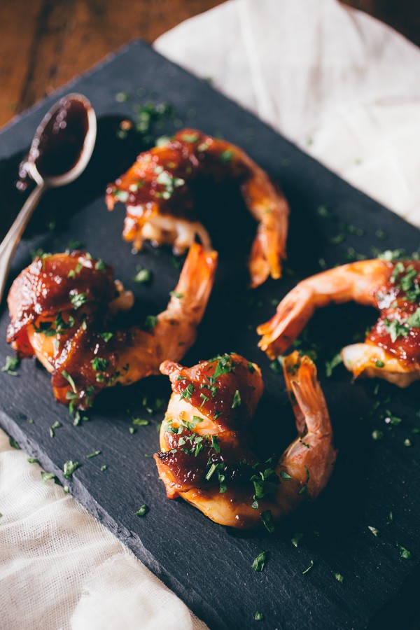 These apple butter bacon wrapped shrimp are the perfect summer appetizer. Extra large shrimp wrapped in bacon and glazed with a sweet and spicy apple butter glaze.