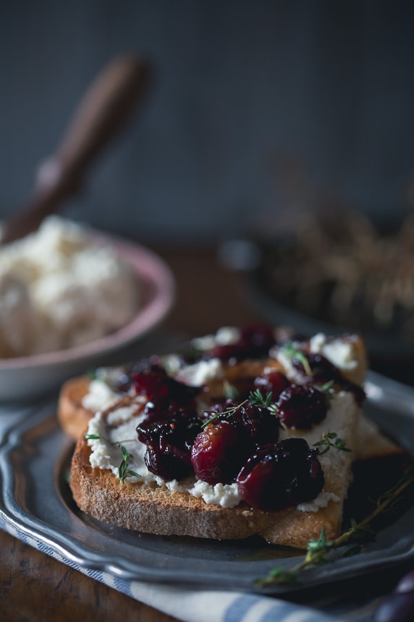 This roasted grape crostini is flavored with fresh thyme and piled high on top of ricotta toast. Super easy to make and ready in under 30 minutes!