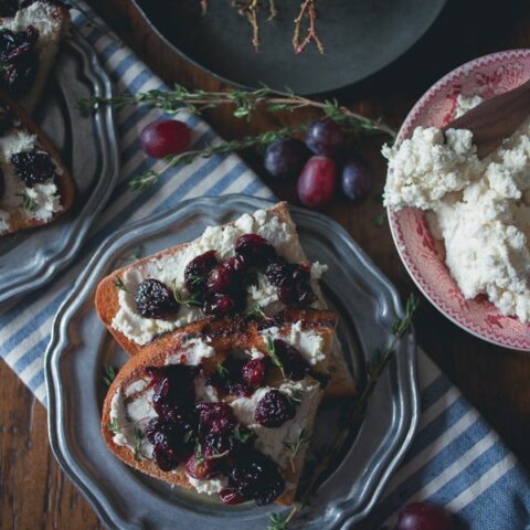 This roasted grape crostini is flavored with fresh thyme and piled high on top of ricotta toast. It's a sweet and savory appetizer that's perfect anytime of the year.
