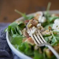 This fig goat cheese salad with fig vinaigrette is the perfect late summer salad. Packed full of fresh figs, goat cheese, pistachios and a homemade fig vinaigrette.