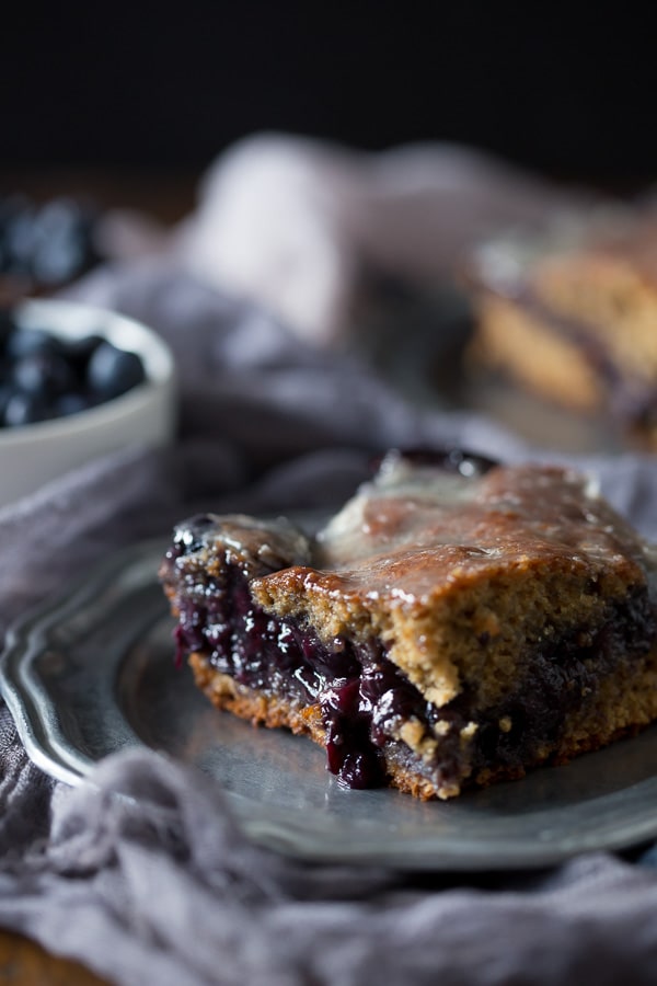 This blueberry fritter cake is the perfect way to celebrate the bounty of summer - sweet cinnamon scented cake with a warm blueberry center topped with vanilla bean glaze. It's like you favorite bakery fritter but in easy to make cake form. Trust me, you'll love the taste of the cake and it's perfect for breakfast or dessert. 