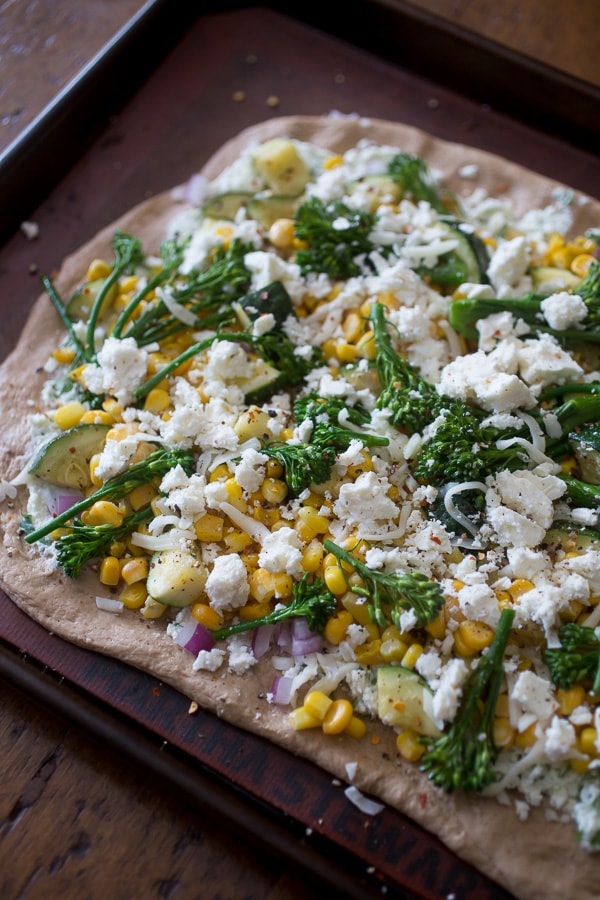 This zucchini corn feta pizza is the perfect way to say goodbye to summer. Packed full of fresh vegetable flavor, cheesy feta and fresh herbs all on a whole wheat crust. 