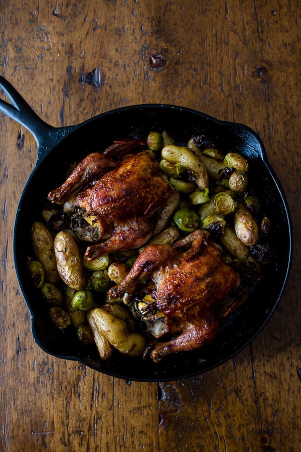 These cranberry bbq sauce cornish hens are perfectly roasted and served with fingerling potatoes and Brussels sprouts. This is one skillet deliciousness! 