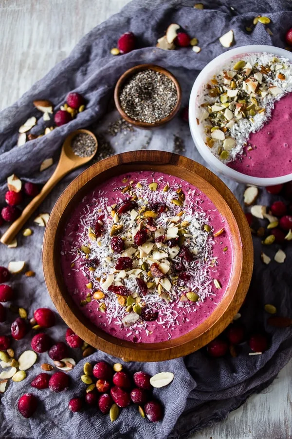 This cranberry smoothie bowl is packed full of cranberries, mixed berries, bananas, almond milk and topped with coconut, chia seeds and nuts. It's healthy, delicious and the perfect holiday rush breakfast.
