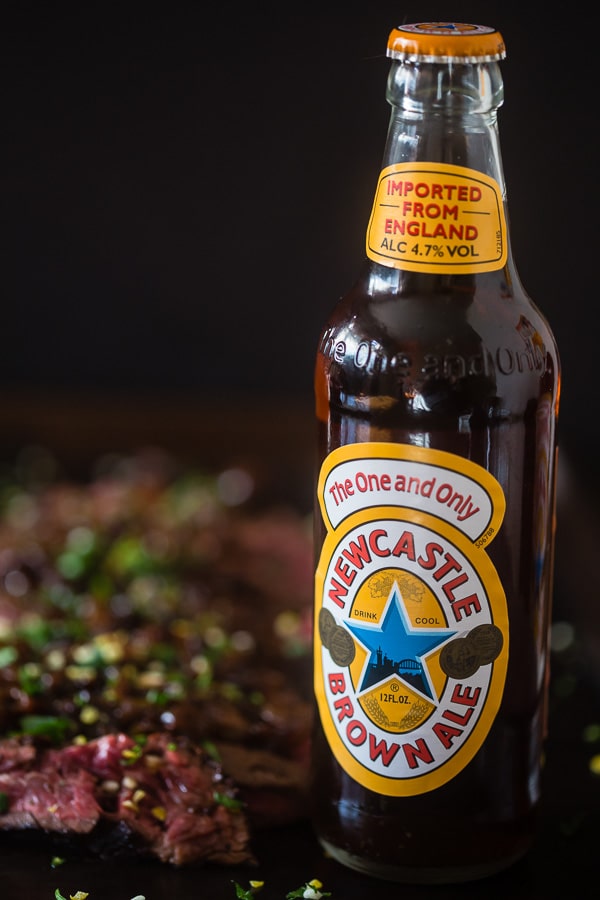 This Newcastle brown ale marinated hanger steak is the perfect holiday meal. Perfectly cooked and topped with Newcastle caramelized onions. You need this!