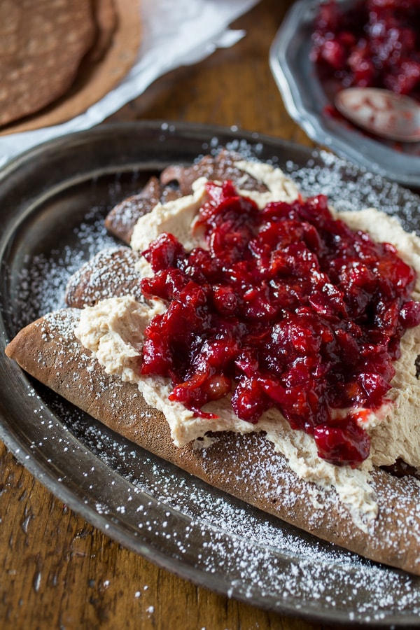 These gingerbread crepes with ginger cranberry compote are the perfect winter dessert. Full of fluffy vanilla mascarpone filling and ready in under an hour!