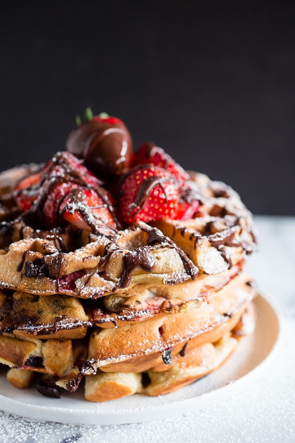 These chocolate covered strawberry buttermilk waffles are the best breakfast you will ever have! Fresh berries tucked inside a fluffy buttermilk waffle and then drizzled with melted chocolate. How can you not love that? 
