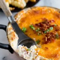 This warm loaded baked potato dip is served warm and full of delicious flavor. Packed full of cream cheese, sour cream, green onions, bacon and of course CHEESE! Perfect when served with french fries or potato chips!