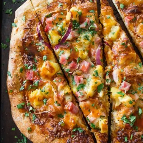 This bbq Hawaiian pizza is the perfect use for all that leftover ham. Tangy bbq sauce topped with melted cheese, red onions, pineapple and ham. You'll love how easy this is to throw together PLUS it's ready in just 25 minutes!