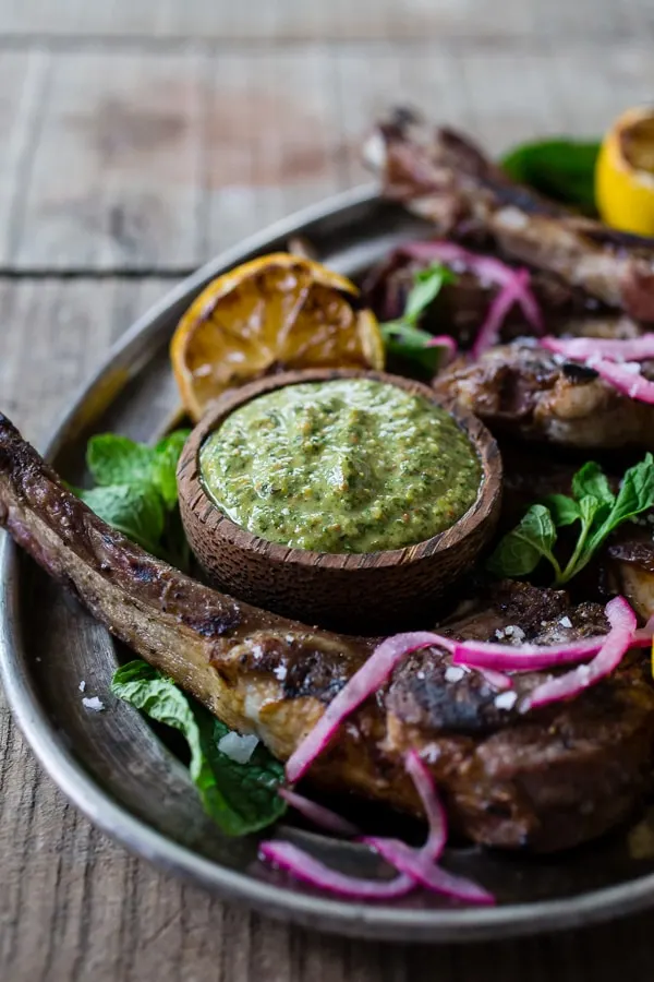 These grilled lamb chops with pistachio mint pesto are a fun way to jazz up your Easter dinner. The whole dish is ready in just 20 minutes and is packed full of springtime flavor. Lightly seasoned lamb drizzled with a homemade pesto that is sure to impress even your pickiest of eaters.