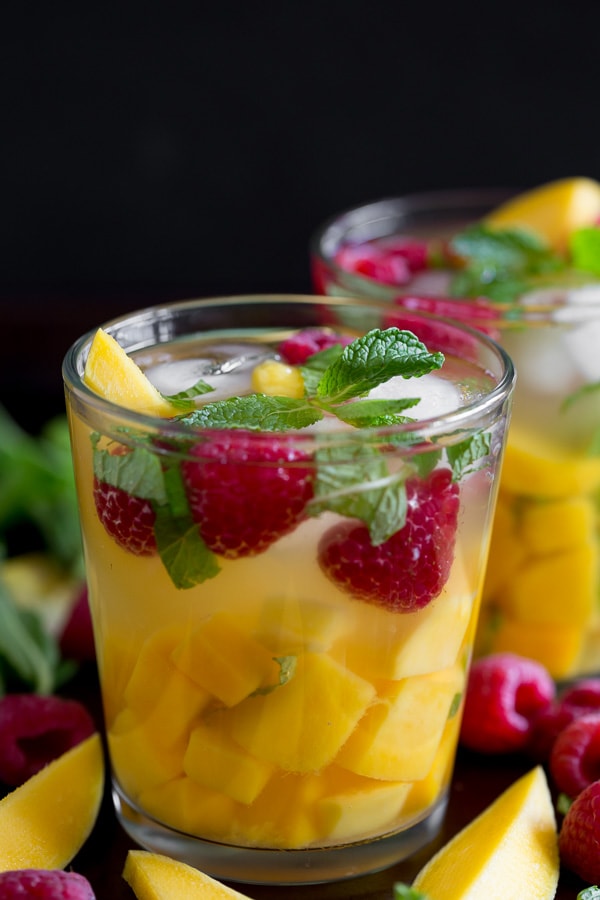 raspberry mango sangria in a glass with lots of mango chunks