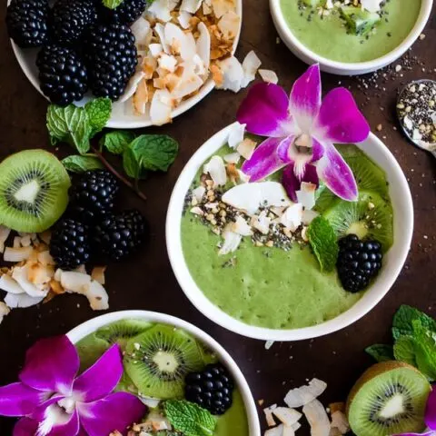 This tropical smoothie bowl is made with frozen bananas, mango, spinach, chia seeds, vanilla soy yogurt and coconut milk. It's ready in just 5 minutes and tastes like a tropical paradise.