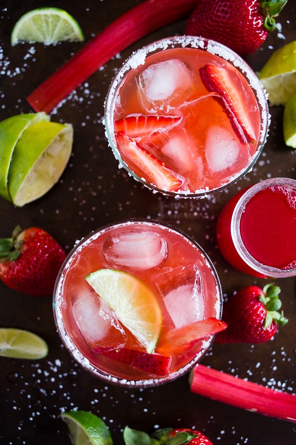 This strawberry rhubarb margarita is the perfect way to celebrate spring and Cinco de Mayo. The perfect balance of sweet, tart and tequila! Made with a homemade strawberry rhubarb syrup and served perfectly chilled on the rocks with a salted rim. Cheers to your new summer drink! 
