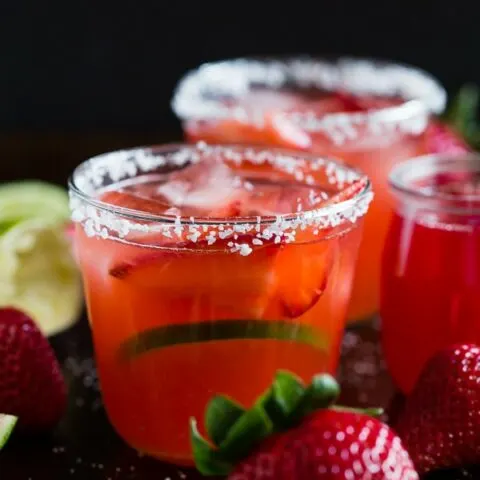 This strawberry rhubarb margarita is the perfect way to celebrate spring and Cinco de Mayo. The perfect balance of sweet, tart and tequila! Made with a homemade strawberry rhubarb syrup and served perfectly chilled on the rocks with a salted rim. Cheers to your new summer drink!