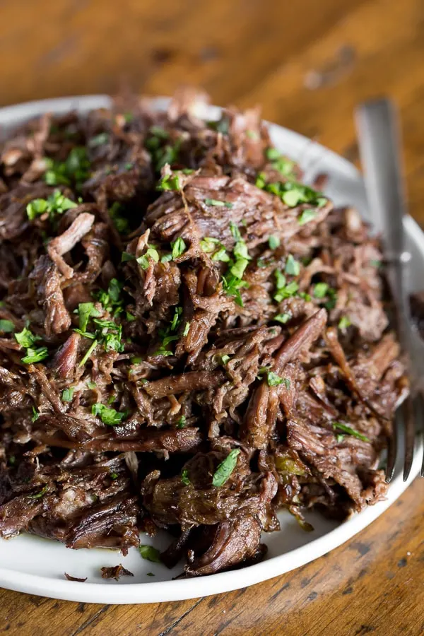 This homemade Mississippi roast is made in the slow cooker and packs some big flavor. Serve over egg noodles, mashed potatoes or even piled high on a bun. Plus this version is 100% homemade so it uses ingredients easily found in your pantry and no flavor packets!