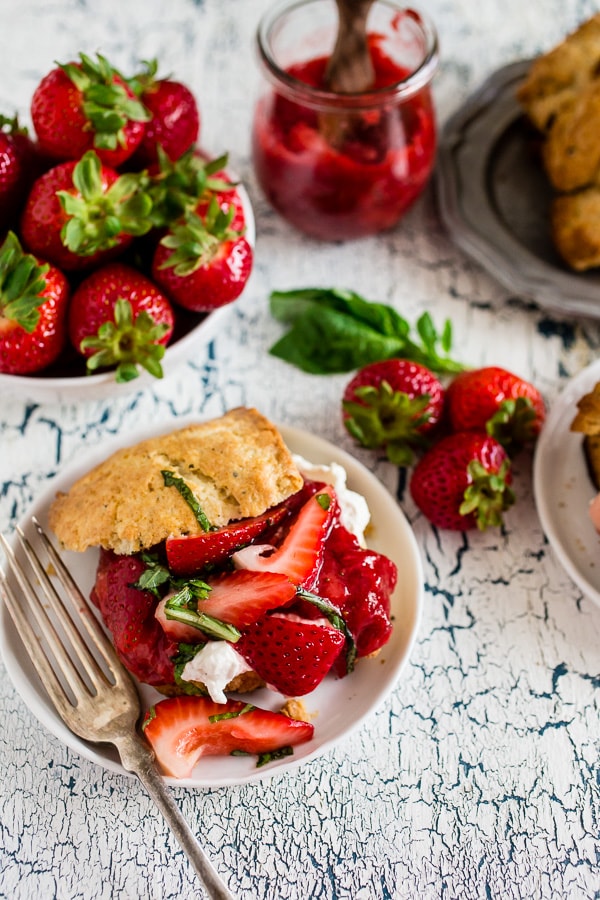 This strawberry basil shortcake is the perfect summertime dessert. Tender shortcake biscuits topped with homemade strawberry jam, macerated berries with basil and fresh whipped cream. So easy and delicious you'll want to make it all summer long. 