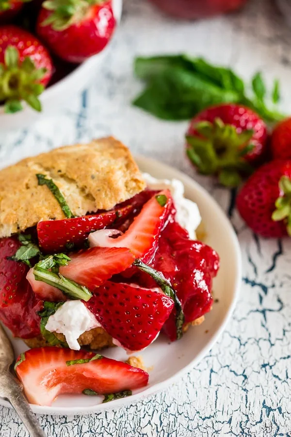 This strawberry basil shortcake is the perfect summertime dessert. Tender shortcake biscuits topped with homemade strawberry jam, macerated berries with basil and fresh whipped cream. So easy and delicious you'll want to make it all summer long.