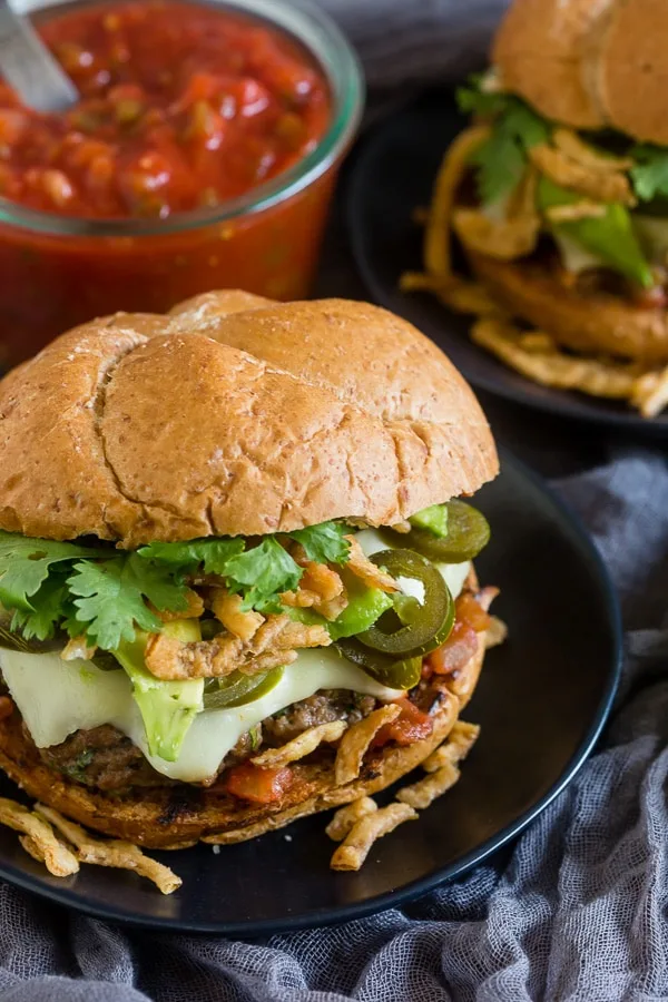 This Baja burger is packed full of fresh summer flavor. The burger patty is studded with fresh jalapeno, lime zest and tons of spices and then it’s topped with melty cheese, salsa, pickled jalapenos, crispy fried onions, avocado and cilantro. You’re gonna love this burger!