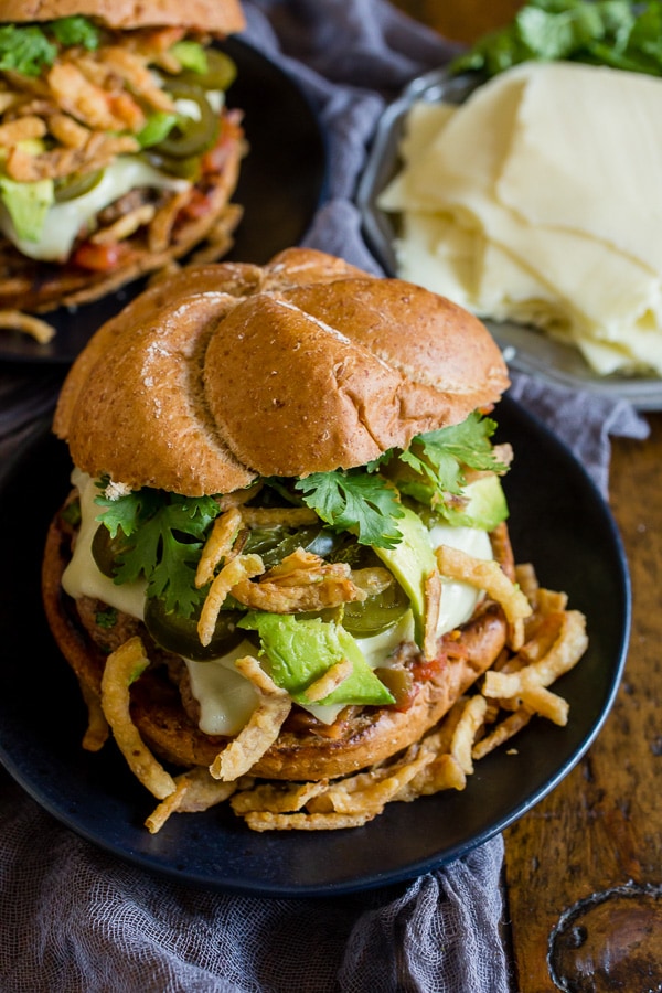 This Baja burger is packed full of fresh summer flavor. The burger patty is studded with fresh jalapeno, lime zest and tons of spices and then it’s topped with melty cheese, salsa, pickled jalapenos, crispy fried onions, avocado and cilantro. You’re gonna love this burger!