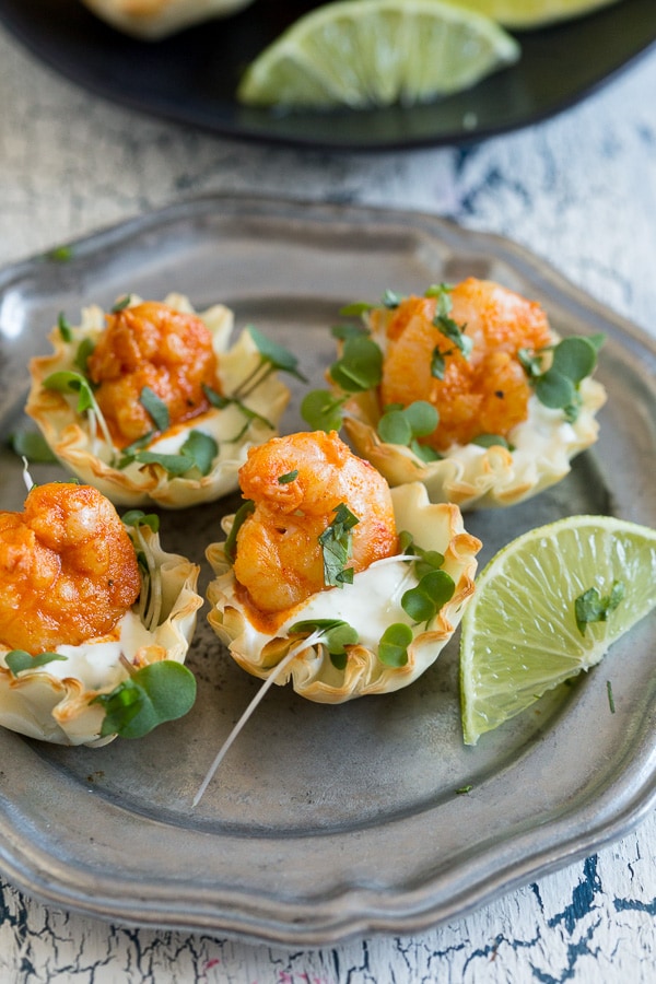 These tequila lime shrimp phyllo cups are the perfect bite size appetizer. Slightly spicy but with a dollop of cooling lime sour cream sauce. You'll love this simple and easy appetizer!
