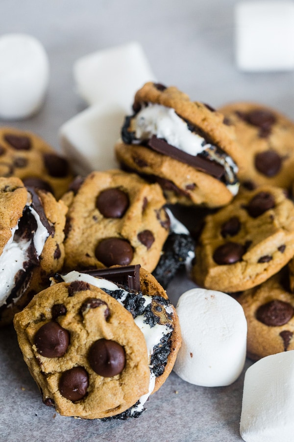 These peanut butter chocolate chip cookie s'mores take all the flavor of a childhood favorite and kick it up a few notches! What's not to love about toasted marshmallows and dark chocolate sandwiched in between peanut butter chocolate chip cookies?