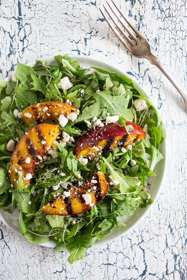 This grilled nectarine salad combines two of my favorite summer things - salads and grilling! Sweet nectarines lightly grilled and tossed into a bed of arugula, ricotta salata and drizzled with a light honey balsamic dressing. You'll love how much flavor is packed into this beauty!