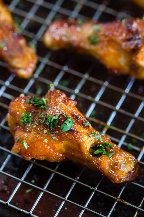 These sweet and spicy honey sriracha chicken wings are the perfect game day appetizer or weeknight dinner. Baked in the oven so they come out super crispy and glazed to perfection.