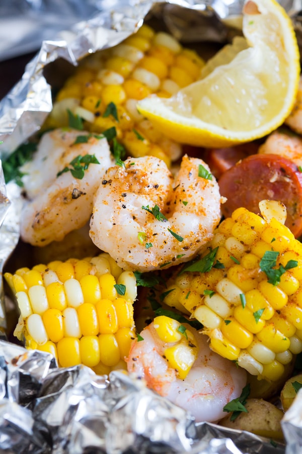 close up pictures of shrimp and corn inside low country boil foil packets