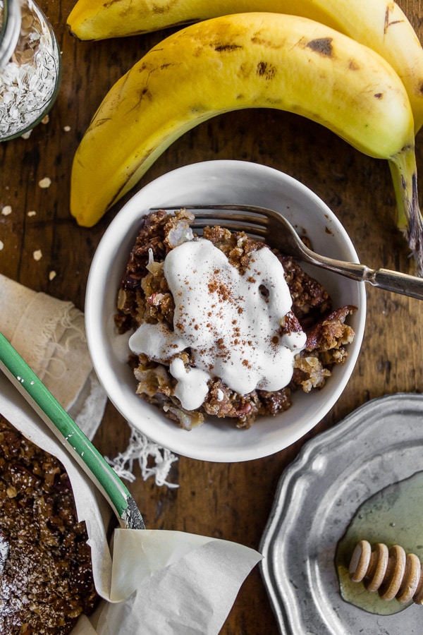 Banana Bread Crisp in a bowl topped with cream. 
