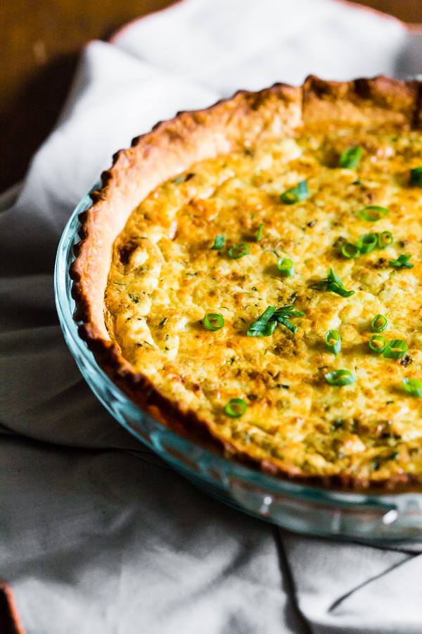 Bacon Onion Herb Quiche topped with chopped green onions. 