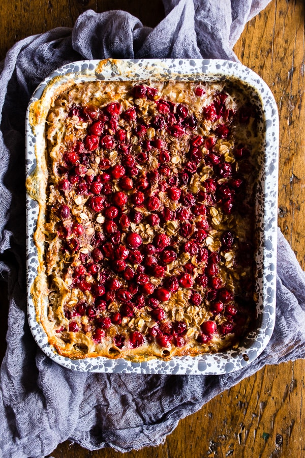 This baked cranberry oatmeal is ready in under an hour and reheats perfectly for a hearty breakfast all week long. Plus it's a great use for all those fall cranberries and delicious maple syrup.
