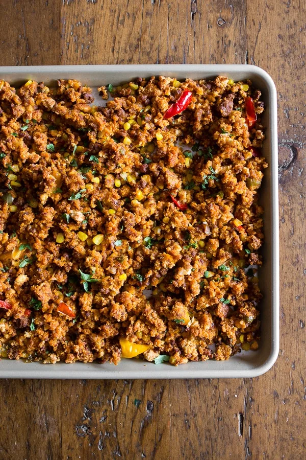 This chorizo sheet pan stuffing is packed full of cornbread, chorizo, peppers, onions and garlic. It's the perfect spicy twist to your normal every day Thanksgiving stuffing. Make your day even easier by prepping the day before and heating up before you feast!