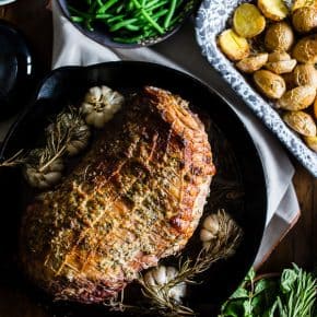 This garlic rosemary roast leg of lamb is the perfect alternative Thanksgiving dinner. Full of garlic and fresh herb flavor and roasted to perfection. Great when served alone or piled high on flat bread with homemade tzatziki sauce.