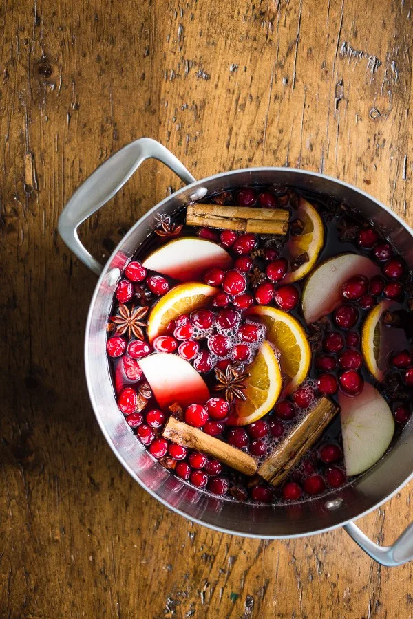 This spiced mulled wine is just what your holiday party needs! Full of red wine, apple cider, whole spices and lots of fresh fruit. You'll love how cozy you'll feel sipping on a mug of this deliciousness.