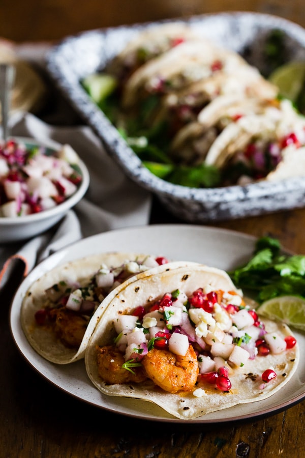 These shrimp tacos with apple pomegranate salsa are the perfect balance of sweet and heat. The shrimp are sauteed in cajun seasoning and topped with a delicious salsa made from apples, pomegranates, red onion, cilantro and lime. You'll love these super easy and crazy delicious tacos. 