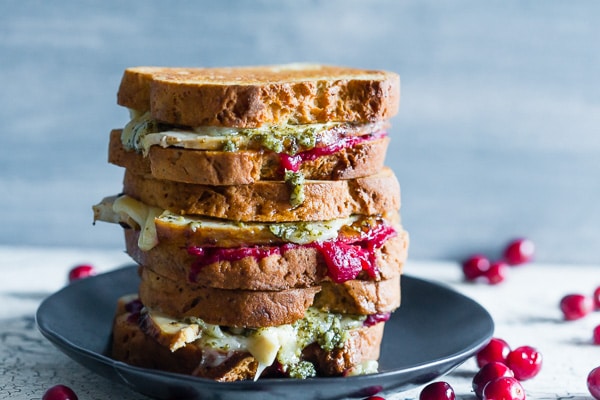 This turkey cranberry pesto panini is the perfect use for all your leftover Thanksgiving turkey and cranberry sauce. Totally delicious and ready in just 15 minutes. You'll love this melty flavor packed panini!