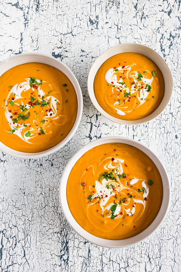 creamy red lentil carrot soup in 3 small bowls