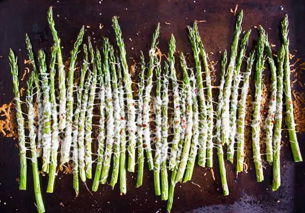 This Parmesan roasted asparagus is sprinkled with Parmesan cheese, crushed red pepper and a little squeeze of lemon. You'll love how simple and delicious this side dish is to make. The best part is the dish is made in just 20 minutes!