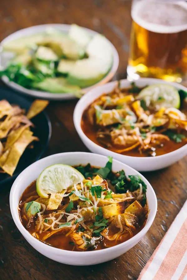 chicken and chard tortilla soup topped with tortilla strips and served with a beer
