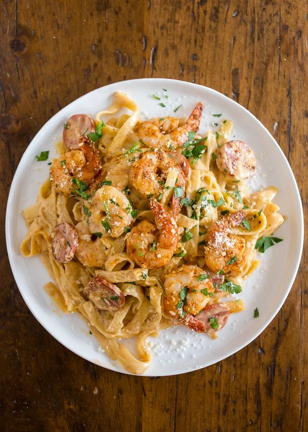 This Cajun shrimp fettuccine alfredo is packed full of flavor with a little Cajun twist. It's perfect for busy weeknights and you'll say goodbye to jarred sauces when you see how easy it is to make your own! Plus the little punch of andouille sausage really brings that Cajun flavor.