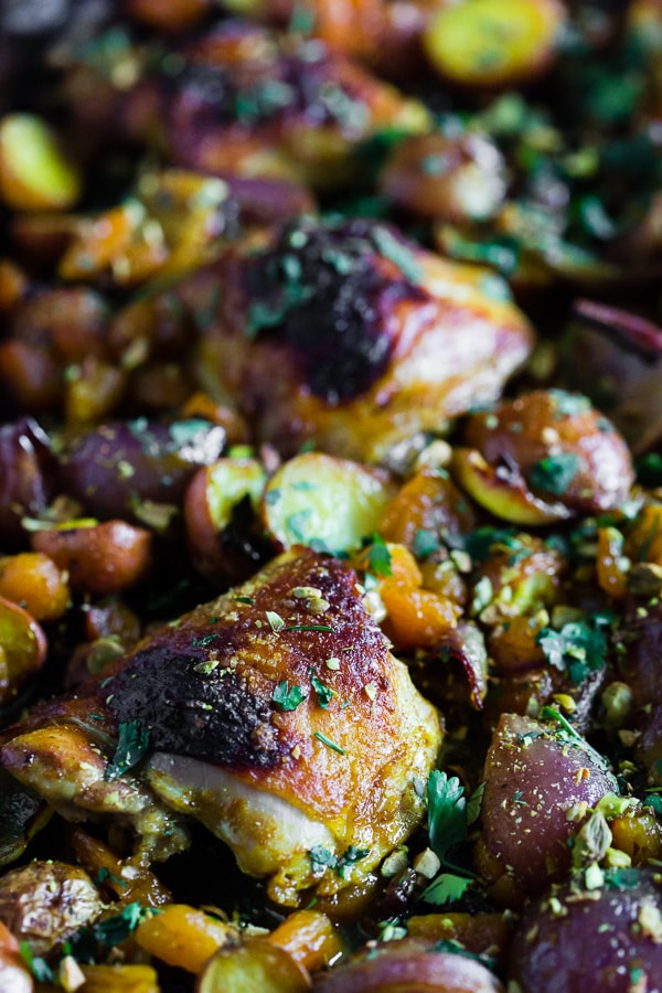 This sheet pan Moroccan chicken and potatoes is flavored with lots of Moroccan spices, dried apricots, golden raisins and a sprinkling of cilantro and pistachios. This dish is super simple to make and only requires 1 sheet pan and 45-50 minutes of roasting!