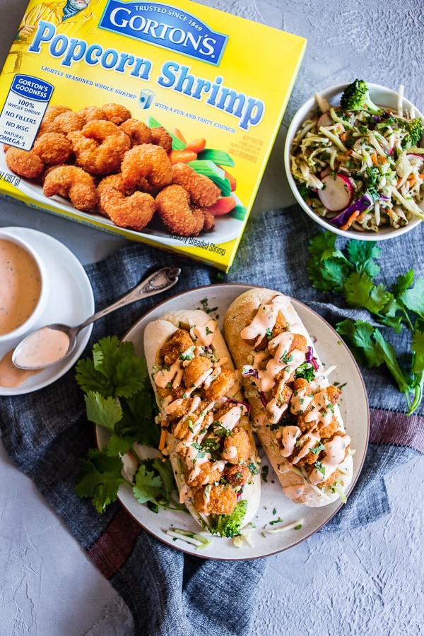 This Asian shrimp po boy sandwich is packed full of flavor and perfect for the busy weeknight meal planning. First, you take a crusty roll and pack it full of a crunchy Asian flavored broccoli slaw, top with crispy baked shrimp and drizzle with spicy Sriracha mayo. You'll love this sandwich!