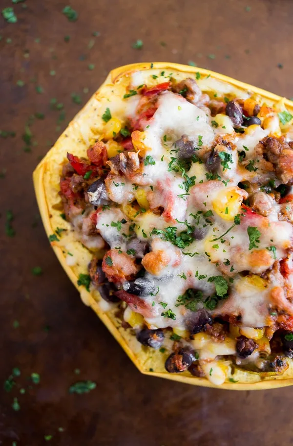 This Southwest taco stuffed spaghetti squash is packed full of ground beef, vegetables, delicious spices and herbs and topped with spicy pepper jack cheese. Super simple to make and a total crowd pleaser. This dish is 100% comfort food!