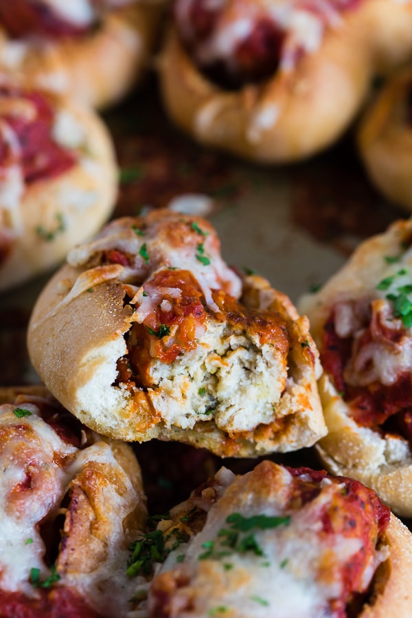 These mini chicken Parmesan meatball subs totally step up your game day food! Stuffed with homemade chicken Parmesan meatballs, tomato sauce and topped with lots of melty mozzarella cheese. Crazy delicious and ready in under an hour!